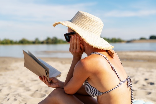 Woman,Reading,Book,On,Sunny,Beach.